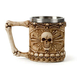 Decorative skull and bone tankard with bone handle, 15cm tall, blends resin charm and stainless steel durability.