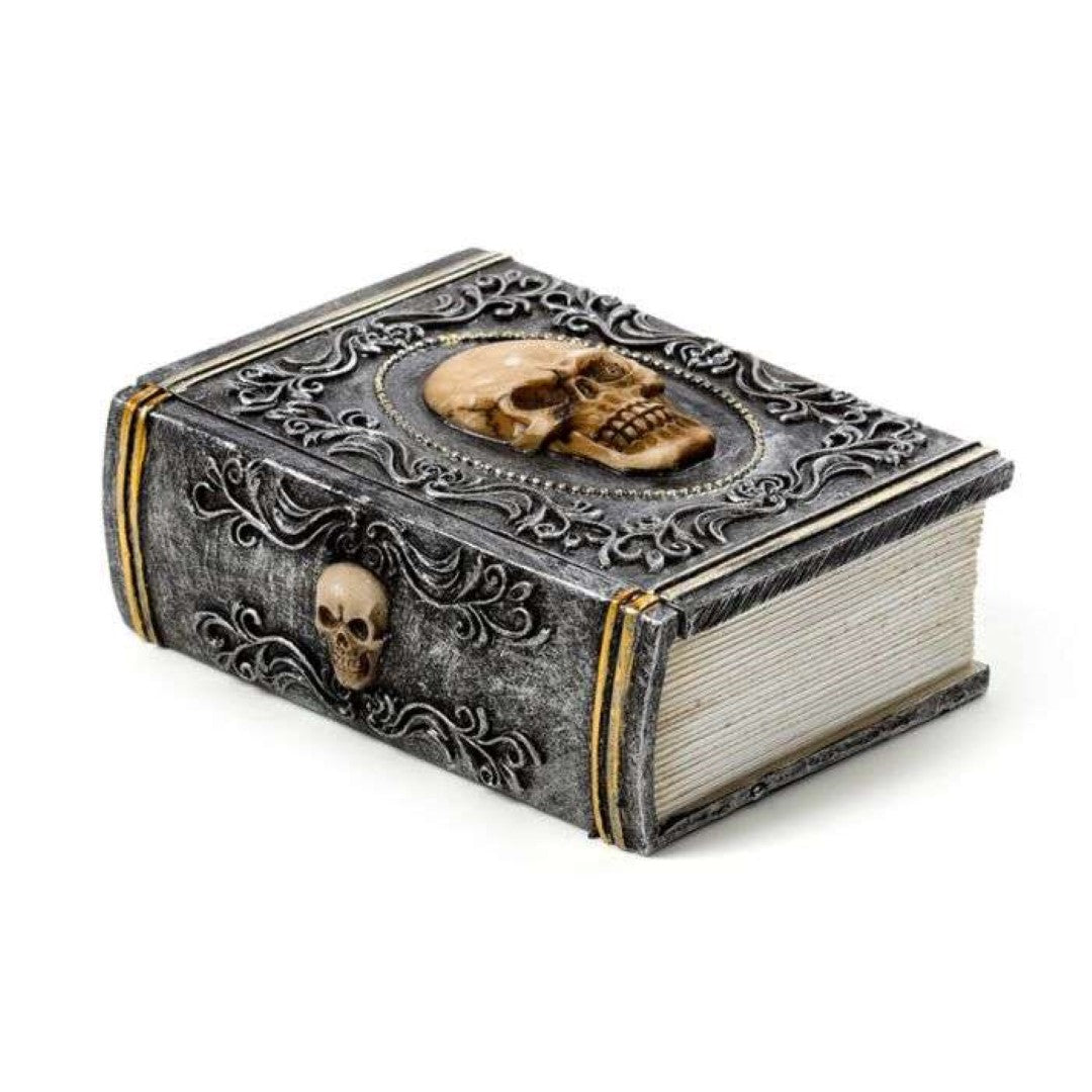 Skull embellished trinket box shaped like a book, perfect for storing jewelry or as a gothic decorative piece.