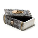 Skull embellished trinket box designed like a book, perfect for storing jewelry or collectibles with gothic charm.