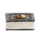 Book-shaped trinket box with skull embellishments, perfect for storing jewelry and showcasing decorative style.