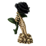 Gothic 17cm skeleton hand ornament holding a black rose, perfect for Halloween decor and striking table centerpiece.