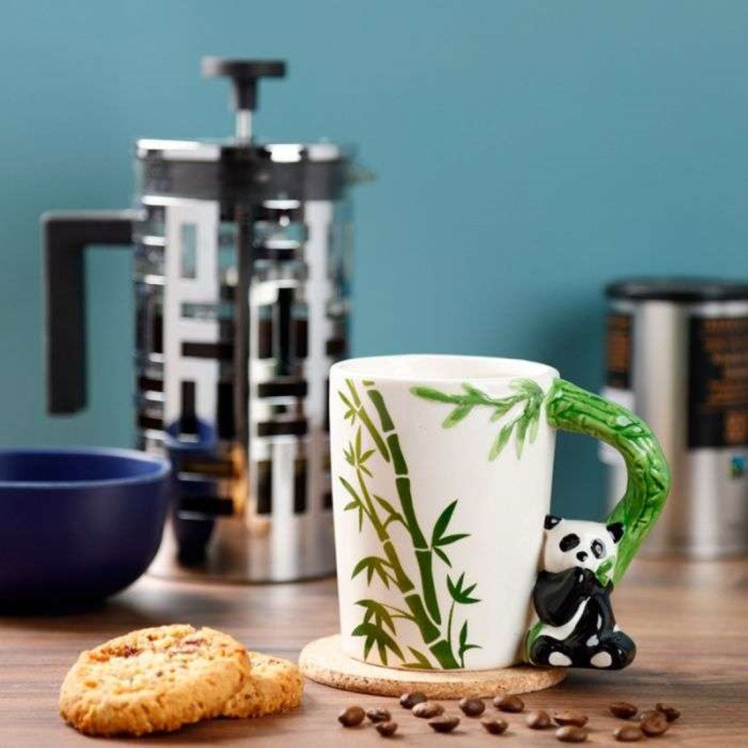 Ceramic mug featuring a panda and bamboo decal, with a unique shaped handle, perfect for stylish sipping.