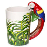 Ceramic mug featuring a parrot and jungle decal, with a unique shaped handle for a vibrant tropical drinking experience.