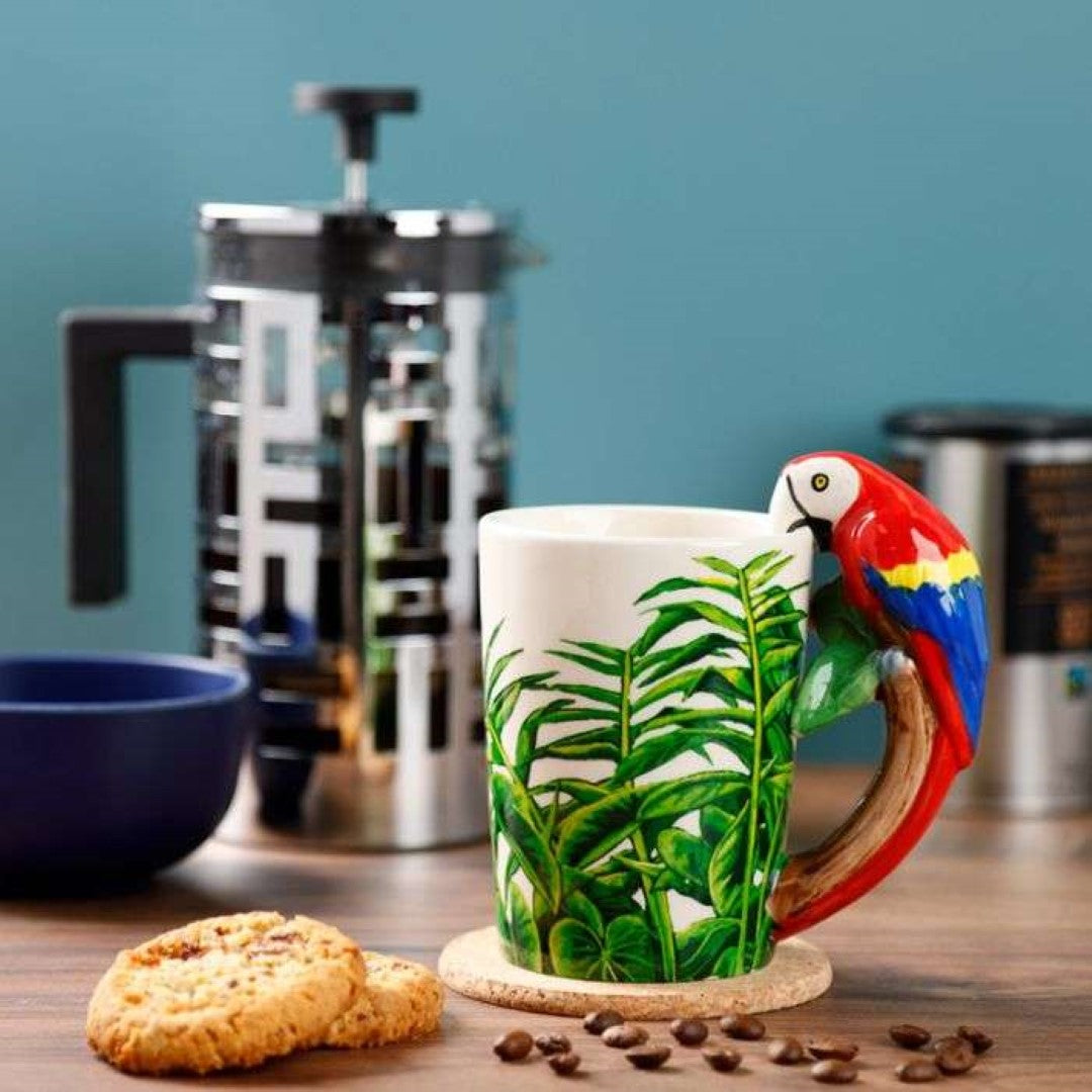 Ceramic mug featuring a parrot design and jungle decal with a unique shaped handle, ideal for hot beverages.