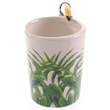 Colorful ceramic mug featuring a toucan design with a jungle-themed handle, perfect for coffee and tea enthusiasts.