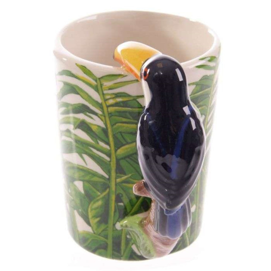 Ceramic mug with vibrant toucan design and jungle-shaped handle, perfect for coffee and tea lovers.