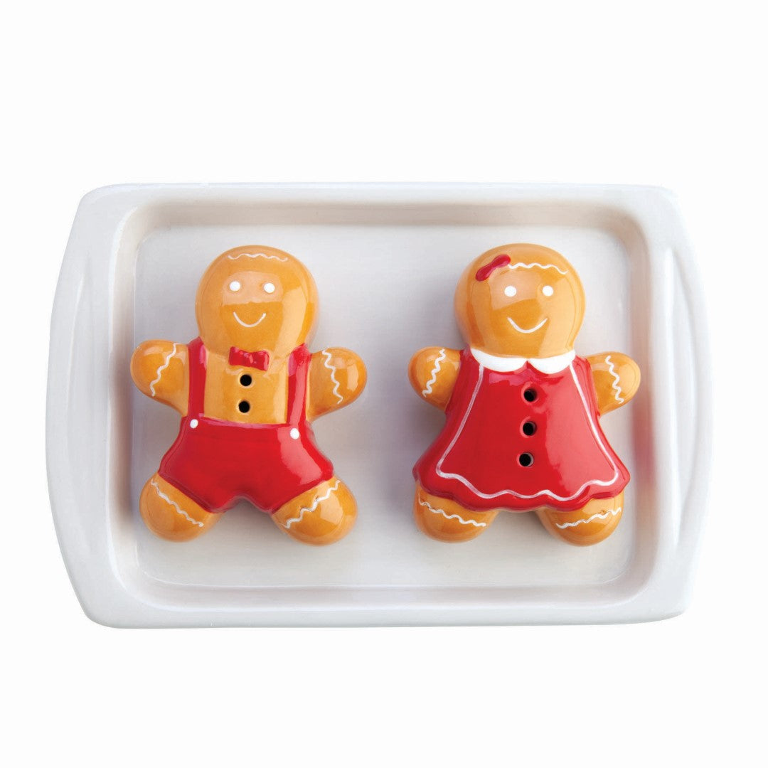 Gingerbread-shaped ceramic salt and pepper shakers in a cute baking tray holder, perfect for festive dining and baking lovers.