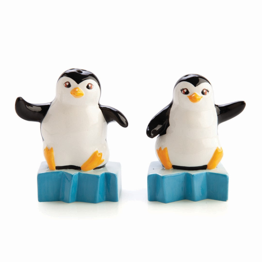 Adorable ceramic salt and pepper shakers shaped like penguins on icebergs, perfect for adding charm to your dining table.