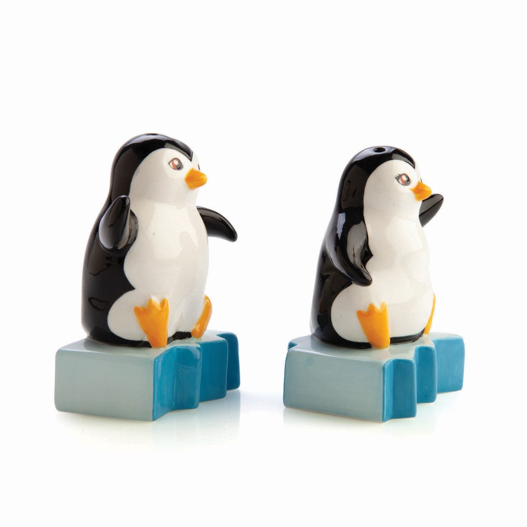 Tea set featuring Mr. & Mrs. Penguin on icebergs, perfect for seasoning and charming table decor.