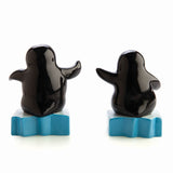 Adorable salt and pepper shakers shaped like penguins on icebergs, perfect for adding charm to dining decor.