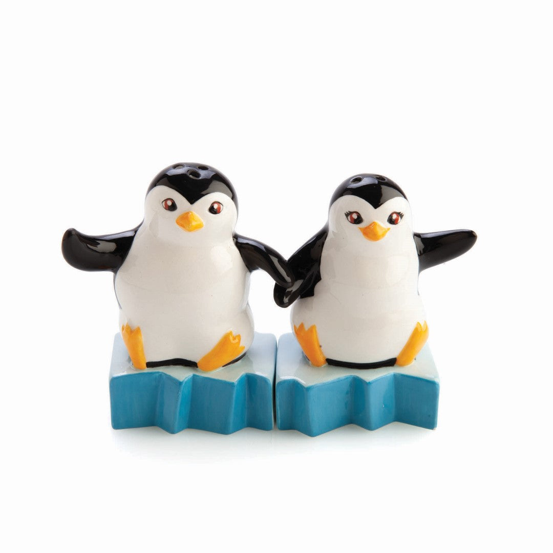 Whimsical salt and pepper shakers shaped like penguins atop icebergs, perfect for adding charm to your dining table.