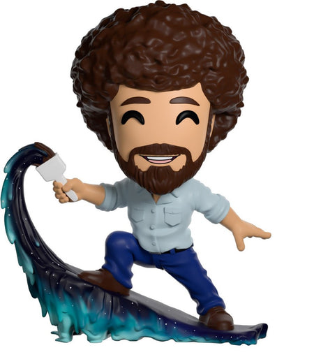 Collectible Youtooz figurine of Bob Ross, featuring his signature smile, paintbrush, and frosty landscape scene, 5 inches tall.