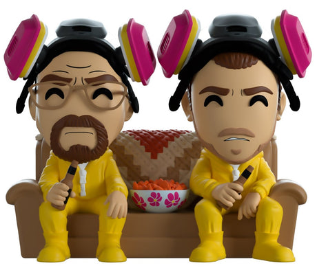 5-inch Youtooz figurine of Walt and Jesse in yellow jumpsuits, relaxing with beers and chips on a brown couch.