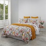 Duvet cover set featuring vibrant spring flowers in pink, yellow, and green on white, made from OEKO-TEX certified cotton.