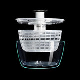 Glass salad spinner with non-slip knob, dual-function basket, and elegant design for easy rinsing and serving salads.