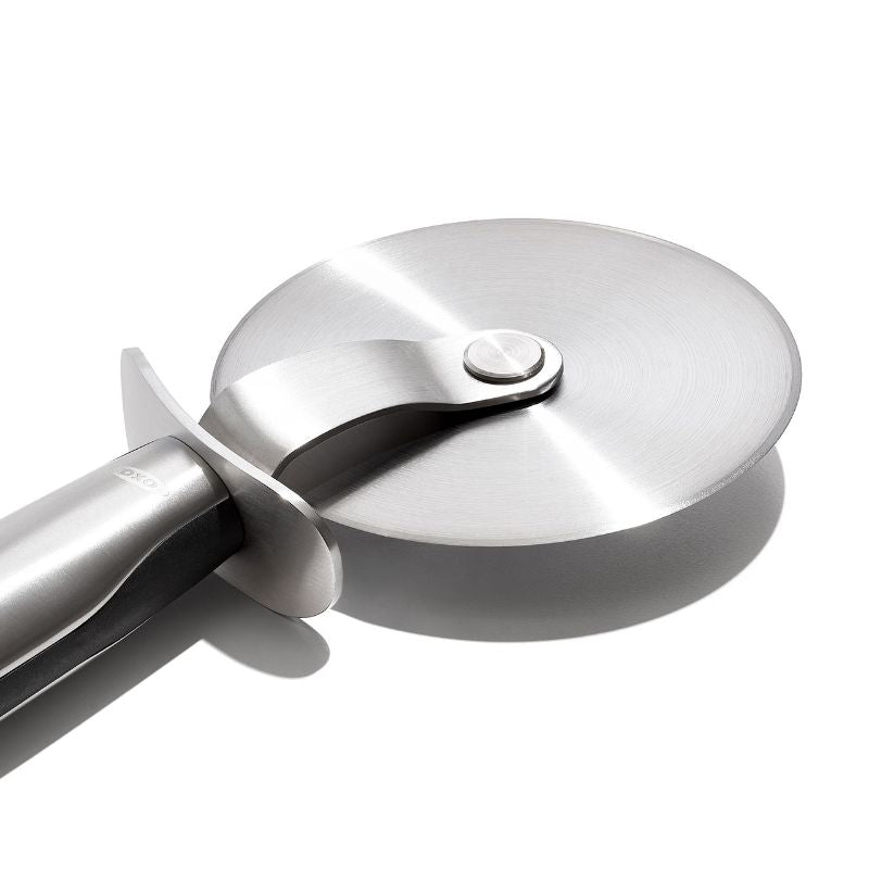 OXO Steel Pizza Wheel with 4-inch stainless steel blade, thumb guard, and non-slip handle for safe, effortless slicing.