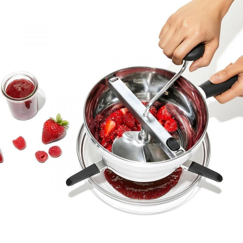 OXO Good Grips Food Mill with stainless steel bowl, three grinding discs, and foldable legs for making sauces and purees.