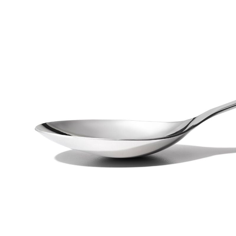 Sleek stainless steel serving spoon with deep well, angled head, and non-slip grip for easy scooping and serving.