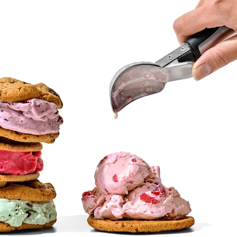 Brushed stainless steel ice cream scoop with pop-up lever and soft grips for effortless serving of frozen treats.