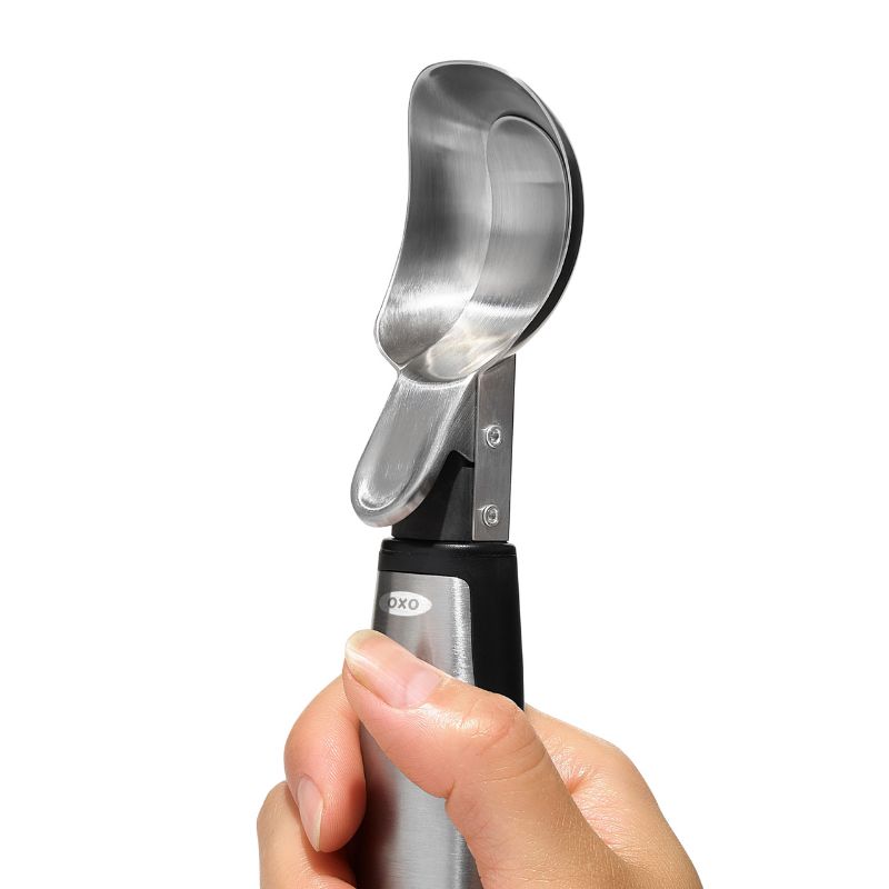 Durable OXO Steel Lever Ice Cream Scoop with pop-up lever and non-slip grip, ideal for effortlessly serving frozen treats.