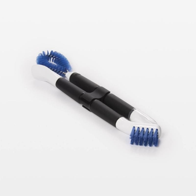 Compact OXO Good Grips cleaning set with nylon brushes and scrapers for deep cleaning tight spaces in kitchen appliances.