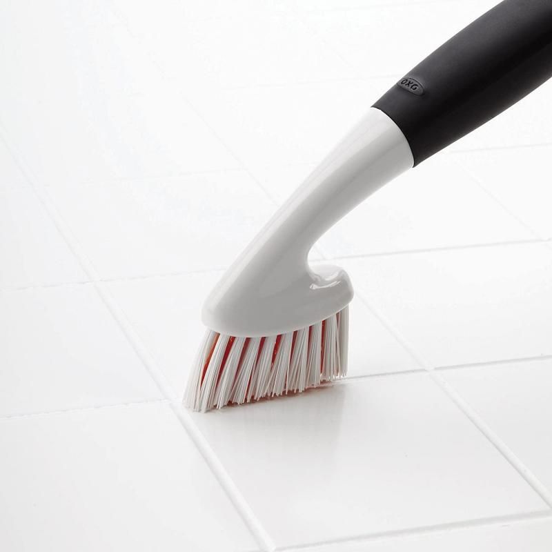 OXO Good Grips Grout Brush with ergonomic handle and tough bristles for easily cleaning grout, tiles, and shower door tracks.