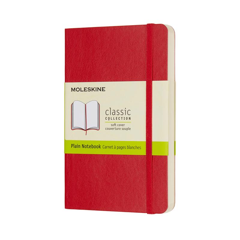 Scarlet red Moleskine Pocket Notebook with soft cover, plain pages, elastic closure, and ribbon bookmark for creative notes.