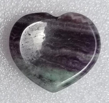 Heart-shaped fluorite worry stone (4cm) for stress relief, meditation, and emotional balance. Unique natural beauty and calming properties.