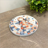 Canvas circle art featuring a whimsical patchwork angel, perfect for home decor and easy to hang.