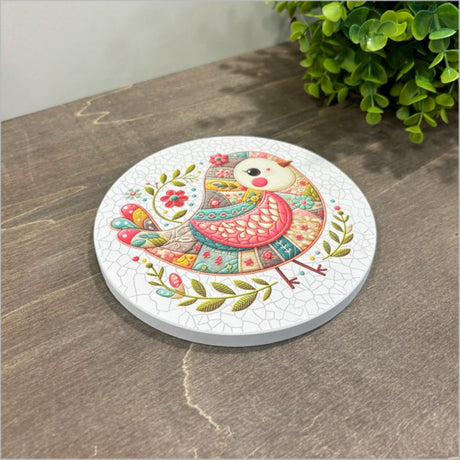 Canvas circle wall art featuring a whimsical pink patchwork bird design, perfect for adding vibrant decor to any space.