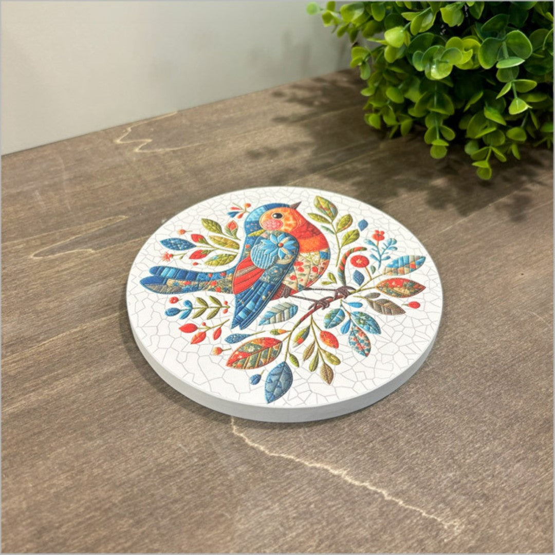 Canvas circle featuring a vibrant patchwork bird design, 150mm, ready to hang, perfect for home or office decor.