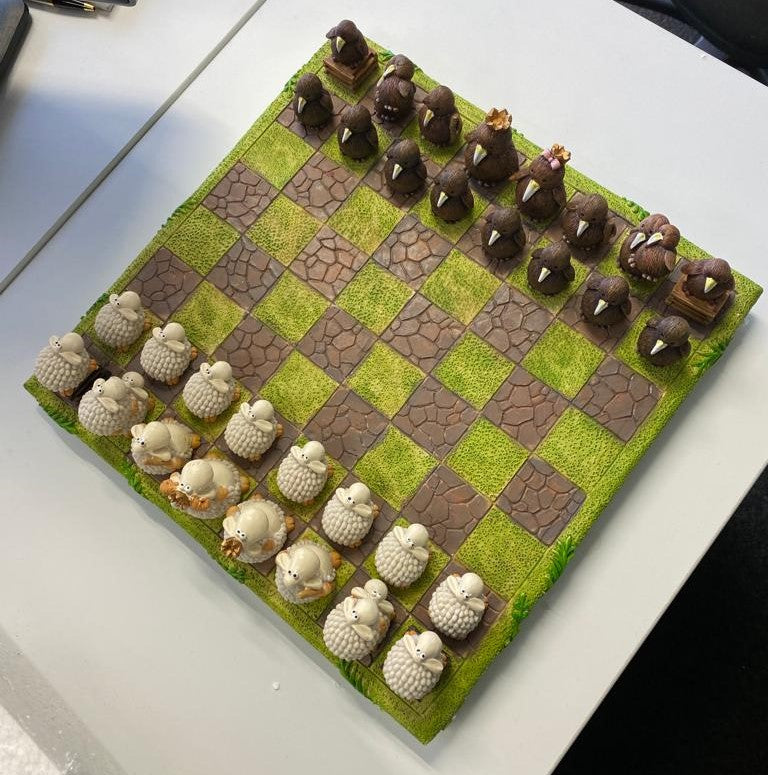 Alt text: Colorful Sheep vs Kiwi chess set featuring whimsical pieces on a lush green board, celebrating New Zealand culture.