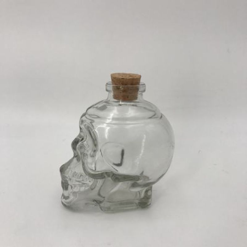 Set of 12 skull-shaped 200ml glass bottles, perfect for serving drinks or sauces with a stylish, edgy design.