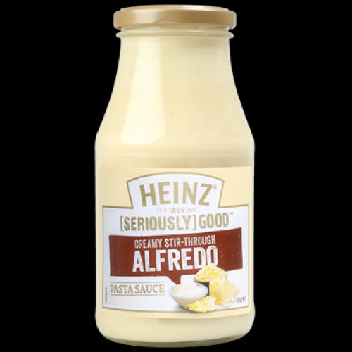 A jar of Heinz Seriously Good Cream Stir-Through Alfredo Pasta Bake, creamy sauce perfect for quick, delicious pasta dishes.