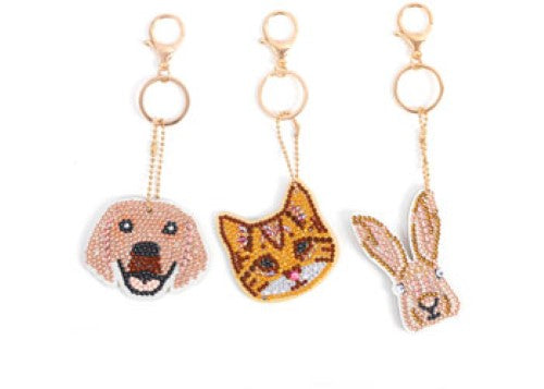 Keyring kit featuring pet designs, vibrant crystals, templates, and tools for creating personalized charms and accessories.