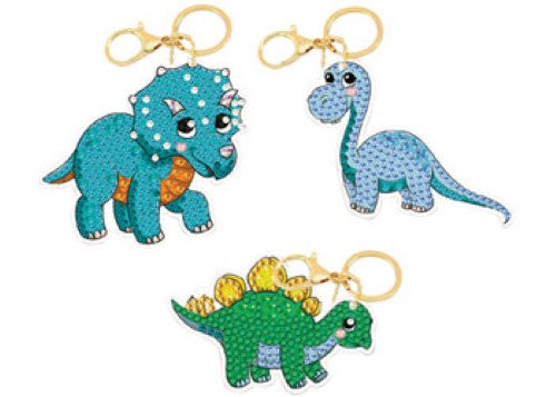 Colorful Dinosaur Friends Keyring Kit featuring three unique designs with sparkling crystals for creative crafting fun.