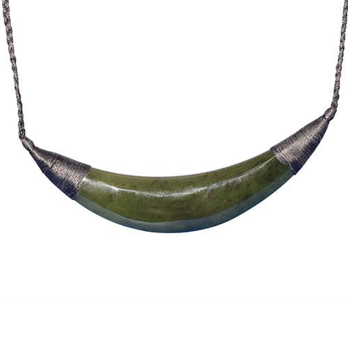 Elegant jade breast plate pendant on a black cord, showcasing Maori craftsmanship and Kiwiana culture from New Zealand.