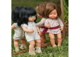 Caucasian girl doll with Down Syndrome, 38cm, soft vinyl, articulated, promotes inclusivity and empathy in children.