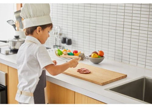 Wooden PlanToys Chef Set featuring utensils, pots, and fresh ingredients for imaginative culinary play in children aged 3+.