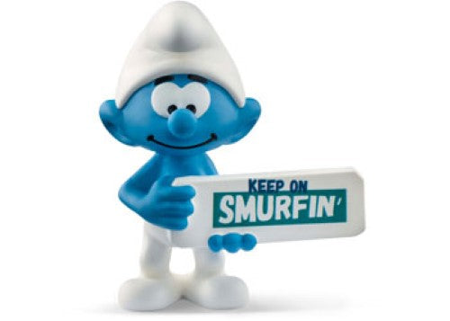Cheerful Smurf figurine holding a "Keep On Smurfin'" sign, perfect for play or display in any collection.
