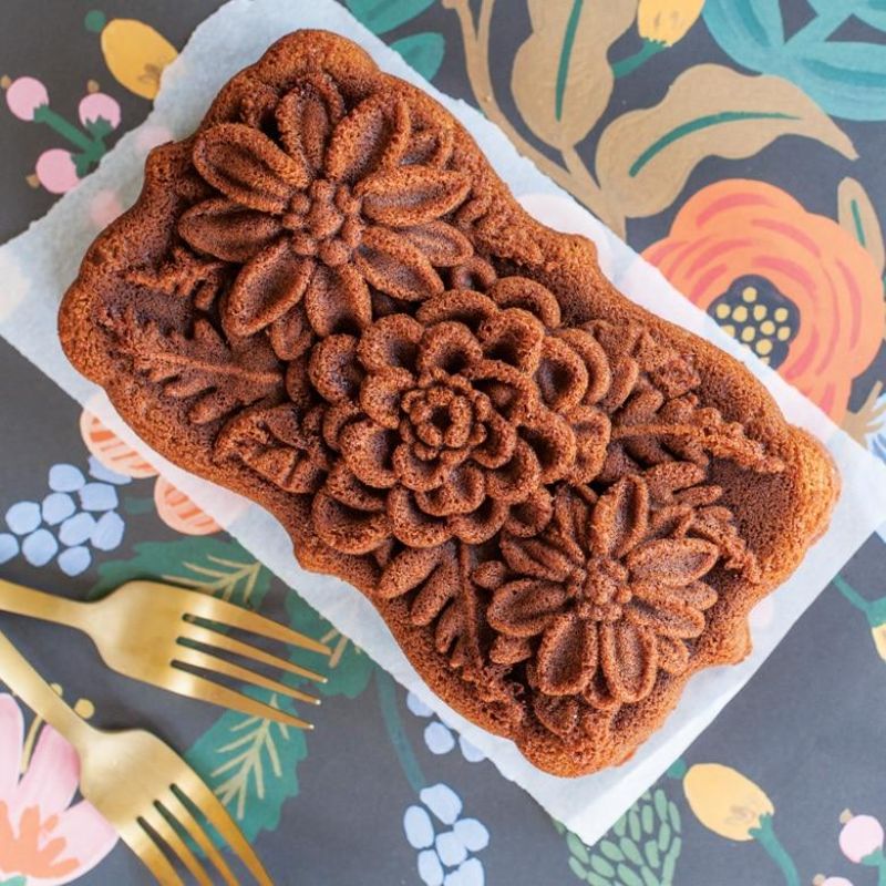 Nordic Ware Wildflower Loaf Pan in Toffee features intricate floral designs, perfect for baking bread or cakes with elegance.