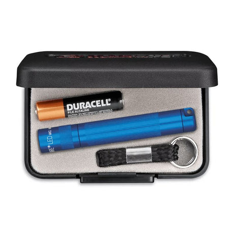 Compact blue Maglite Solitaire LED flashlight in a presentation box, featuring durable aluminum, water and shock resistance.