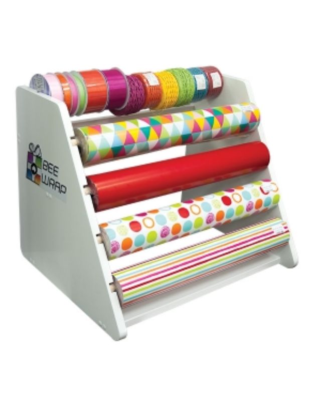 Wooden benchtop wrap dispenser in white, designed to hold rolls of wrapping paper and ribbon for easy access and display.