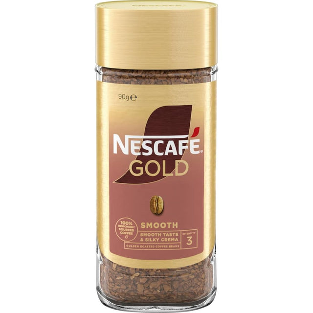 A steaming cup of Nescafe Gold Instant Coffee Smooth topped with golden crema, offering rich flavor and convenience.