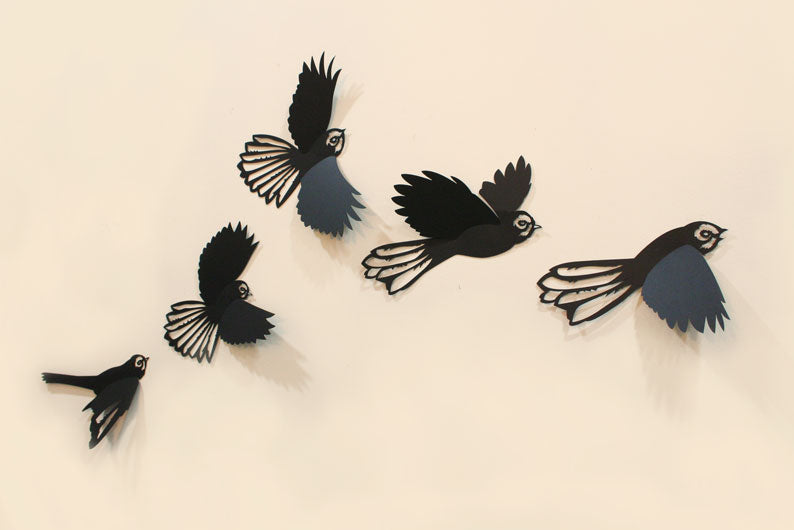 Five black polypropylene fantails in flight, designed for creative wall arrangements, adding nature-inspired charm to any decor.