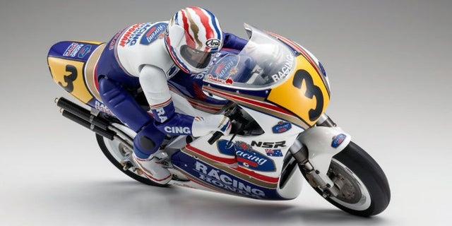 Detailed 1/8 scale Kyosho R/C motorcycle kit of the 1991 Honda NSR500, featuring a Le Mans DM20 motor and advanced rear suspension.