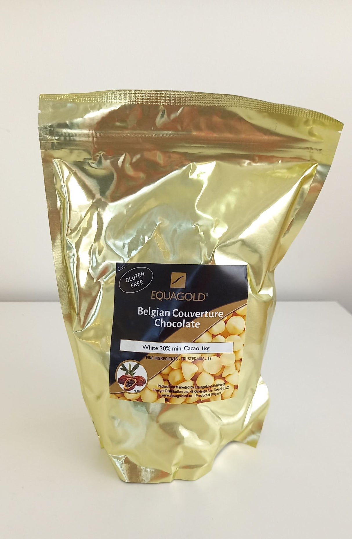 White Belgian chocolate callets in a 1kg packet, perfect for baking, decorating, and snacking with rich, creamy flavor.