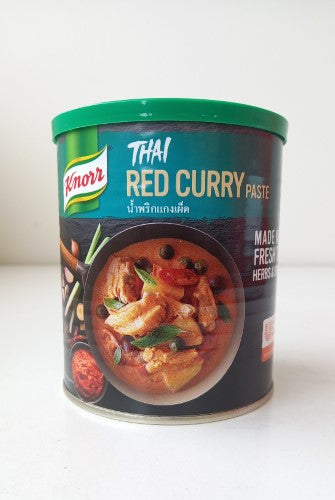 A tub of Knorr 850g Thai Red Curry Paste, perfect for creating authentic, flavorful curry dishes at home.