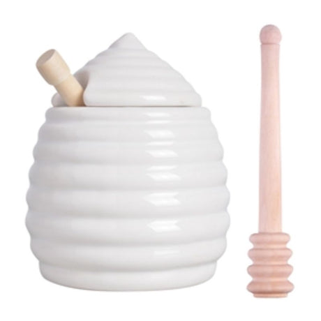 Ceramic honey pot shaped like a beehive with wooden dipper, perfect for serving honey stylishly and neatly.