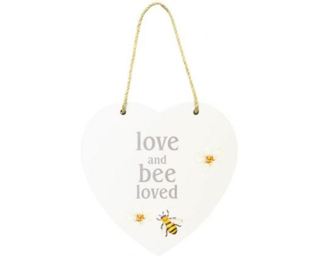 Heart-shaped MDF sign with twine hanger displaying "Love, and Bee Loved", perfect for warm home decor.
